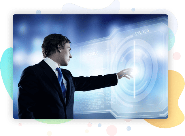 Man in a suit pointing at a screen.